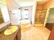 Bathroom with granite counters, soaking tub, and glass shower, offering a spa-like experience at 145 Blue Marlin Dr, Oldsmar, FL 34677
