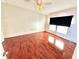 Spacious bedroom featuring hardwood flooring, a ceiling fan, and ample natural light at 145 Blue Marlin Dr, Oldsmar, FL 34677