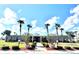 Community clubhouse with accessibility signs, palm trees and manicured landscaping creating a welcoming entrance at 145 Blue Marlin Dr, Oldsmar, FL 34677