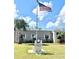 Community clubhouse showcases an American flag and landscaping, fostering neighborhood pride at 145 Blue Marlin Dr, Oldsmar, FL 34677