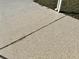 Concrete driveway exhibiting a sealed expansion joint, demonstrating care for maintenance at 145 Blue Marlin Dr, Oldsmar, FL 34677