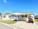 Charming single-story home with a well-manicured lawn and a convenient covered parking area at 145 Blue Marlin Dr, Oldsmar, FL 34677