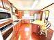 Well-lit kitchen features stainless steel appliances, center island, tile backsplash, and wood cabinets at 145 Blue Marlin Dr, Oldsmar, FL 34677