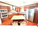 Updated kitchen has wood floors, stainless steel appliances, and kitchen island with seating at 145 Blue Marlin Dr, Oldsmar, FL 34677