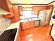This kitchen has stainless steel appliances, tile backsplash, wood floors, and cabinets at 145 Blue Marlin Dr, Oldsmar, FL 34677
