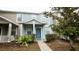 Two-story townhome with light blue exterior and a blue front door at 1552 Blue Magnolia Rd, Brandon, FL 33510