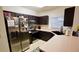 Galley kitchen with stainless steel appliances and dark cabinets at 1552 Blue Magnolia Rd, Brandon, FL 33510