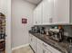 Butlers pantry with granite countertop and coffee bar at 16959 Scuba Crest St, Wimauma, FL 33598