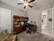 Spacious home office with desk, seating, and access to a full bathroom at 16959 Scuba Crest St, Wimauma, FL 33598