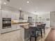 Spacious kitchen with granite countertops, stainless steel appliances, and white cabinetry at 16959 Scuba Crest St, Wimauma, FL 33598
