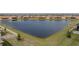 Community lake view with homes and lush landscaping at 16959 Scuba Crest St, Wimauma, FL 33598