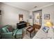 Spacious living room with seating, piano, and access to a bathroom at 16959 Scuba Crest St, Wimauma, FL 33598