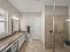 Main bathroom featuring a walk-in shower and double vanity at 16959 Scuba Crest St, Wimauma, FL 33598