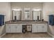 Double vanity bathroom with granite countertops and ample storage at 16959 Scuba Crest St, Wimauma, FL 33598