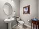 Elegant powder room with pedestal sink and decorative framed art at 16959 Scuba Crest St, Wimauma, FL 33598