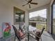Charming screened patio with glass-top table and seating for four at 16959 Scuba Crest St, Wimauma, FL 33598