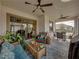 Spacious screened patio featuring comfortable seating and a dining area at 16959 Scuba Crest St, Wimauma, FL 33598