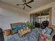 Covered patio with wicker furniture and tropical plants at 16959 Scuba Crest St, Wimauma, FL 33598