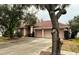 Two-story house with three-car garage and manicured lawn at 18108 Sugar Brooke Dr, Tampa, FL 33647