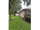 Side view showing well-maintained yard and white fence at 18108 Sugar Brooke Dr, Tampa, FL 33647