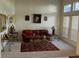 Living room features a brown leather couch and area rug at 18108 Sugar Brooke Dr, Tampa, FL 33647