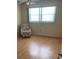 Bedroom with wood floors, window, and comfortable chair at 1819 Shore S Dr # 315, South Pasadena, FL 33707
