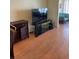 Bright living room with wood floors and large TV at 1819 Shore S Dr # 315, South Pasadena, FL 33707