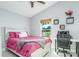 Cozy bedroom with a queen-size bed, and a window view of the backyard at 18410 Oriole St, Lutz, FL 33558