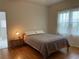 Cozy bedroom featuring hardwood floors and a window at 2327 Woodlawn E Cir, St Petersburg, FL 33704