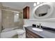 Bathroom with dark vanity, shower/tub combo, and linen cabinet at 2351 Irish Ln # 21, Clearwater, FL 33763