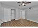 Bedroom with wood-look floors, closet, and ceiling fan at 2351 Irish Ln # 21, Clearwater, FL 33763