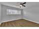 Well lit bedroom with hardwood floors and large window at 2351 Irish Ln # 21, Clearwater, FL 33763