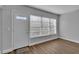 Bright entryway with wood-look floors, a white door and large window with blinds at 2351 Irish Ln # 21, Clearwater, FL 33763