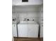 Bright laundry room, washer, dryer, and shelving at 2351 Irish Ln # 21, Clearwater, FL 33763