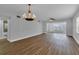 Spacious living room with wood-look floors and chandelier at 2351 Irish Ln # 21, Clearwater, FL 33763