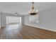 Bright living room featuring hardwood floors, chandelier, and large windows at 2351 Irish Ln # 21, Clearwater, FL 33763