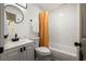 Clean bathroom with white vanity, tub, and orange shower curtain at 2353 Shelley St # 15, Clearwater, FL 33765