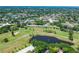 Aerial view of community with golf course, pond, and residential buildings at 2402 Ecuadorian Way # 28, Clearwater, FL 33763