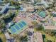 Aerial view showing tennis courts, pool, and community buildings at 2402 Ecuadorian Way # 28, Clearwater, FL 33763