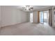 Bright bedroom featuring carpet flooring, sliding glass doors, and a ceiling fan at 2402 Ecuadorian Way # 28, Clearwater, FL 33763