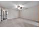 Large carpeted bedroom with ceiling fan and access to another room at 2402 Ecuadorian Way # 28, Clearwater, FL 33763