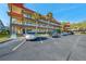Two-story condo building with ample parking and tropical landscaping at 2402 Ecuadorian Way # 28, Clearwater, FL 33763