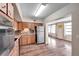 Kitchen with wood cabinets, stainless steel appliances, and vinyl flooring at 2402 Ecuadorian Way # 28, Clearwater, FL 33763
