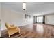 Living room with wood flooring, a large window and a yellow armchair at 2402 Ecuadorian Way # 28, Clearwater, FL 33763