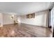 Spacious living room with wood-look floors and a comfortable chair at 2402 Ecuadorian Way # 28, Clearwater, FL 33763