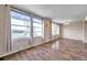 Living room with large windows and hardwood floors at 2402 Ecuadorian Way # 28, Clearwater, FL 33763