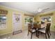 Dining room with wood table, chairs, and large windows at 272 Portree Dr, Dunedin, FL 34698