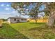 Spacious backyard with large tree and wood fence at 2724 20Th S St, St Petersburg, FL 33712