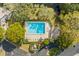 Community pool and surrounding landscape from above at 2805 Delachaise Ct # 75, Clearwater, FL 33761