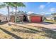 One-story home with red garage door, stone accents, and landscaped yard at 29526 Tee Shot Dr, San Antonio, FL 33576